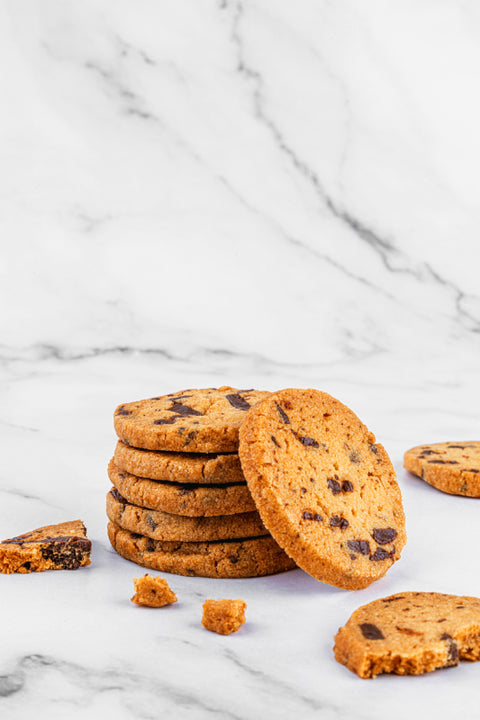 Image of Chocolate Sea-Salt Sablés by Laura's Home Bakery, showcasing their rich chocolate chips and delicate sea-salt crystals atop golden-brown cookies.