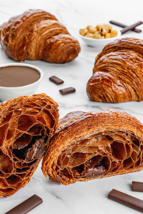 Image of a Triple Chocolate Croissant from Laura's Home Bakery, showcasing its buttery and chocolatey layers within flaky interior of a Triple Chocolate Croissant from Laura's Home Bakery.