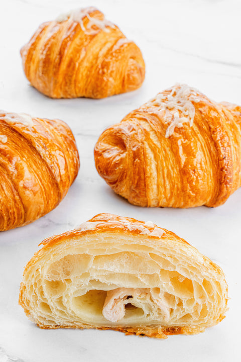 Image of a Turkey & Cheese Croissant from Laura's Home Bakery, showcasing its flaky texture, tender turkey slices, and premium cheese filling.