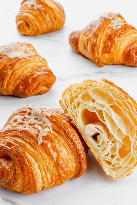 Close-up image of a savory Turkey & Cheese Croissant from Laura's Home Bakery, highlighting its flaky golden crust and a delicious filling of tender turkey slices and premium cheese.