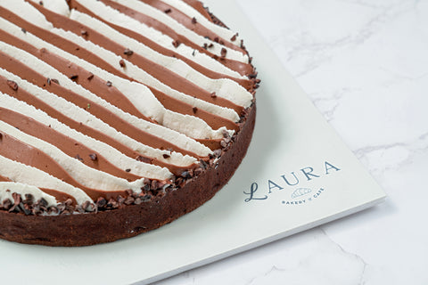 Side Image of a Triple Chocolate Tart with White Vanilla Ganache and Chocolate Whipped Cream from Laura's Home Bakery, showcasing its luxurious toppings and decadent chocolate layers.