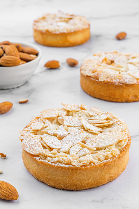 Image of mini Almond Tart, beautifully garnished with sliced almonds, a perfect nutty treat for almond enthusiasts from our home bakery