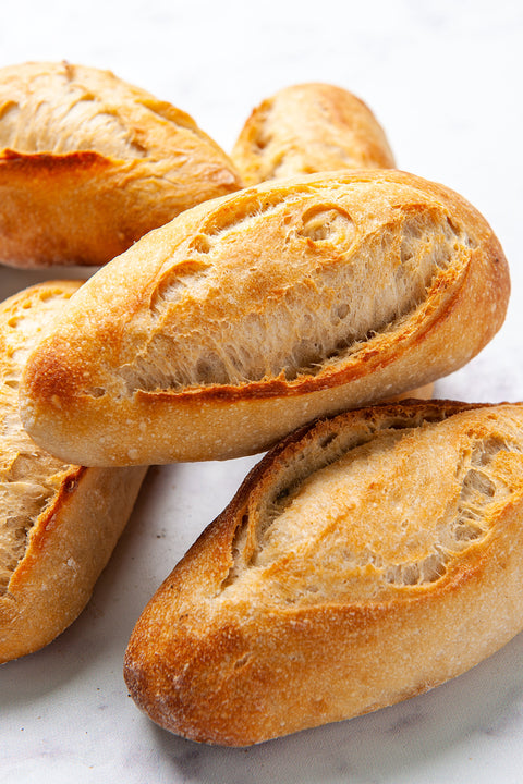 Image of small baguettes, freshly baked with a golden crust and a soft, airy interior