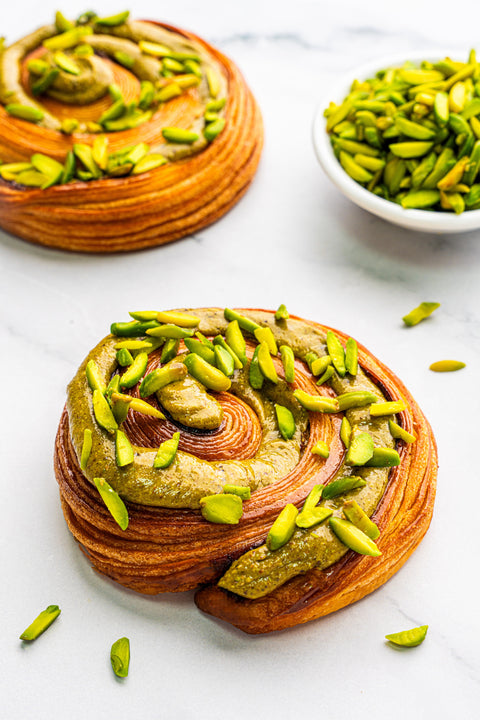 Image of Pistachio Rolls from Laura's Home Bakery, showcasing their nutty crushed pistachio filling and tender, flaky layers.