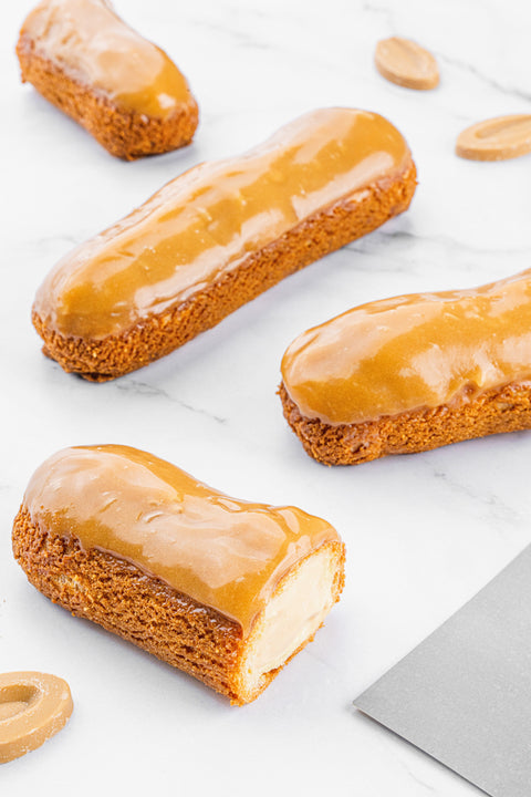 Image of Éclair Salted Caramel from Laura's Home Bakery, showcasing its luscious caramel drizzle and delicate pastry layers, a sweet delight to savor.