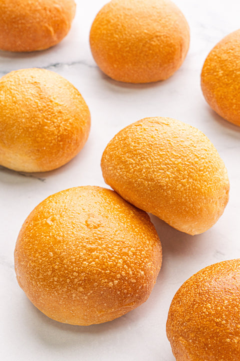 Image of a set of Mini Burger Buns from Laura's Home Bakery, showcasing their golden-brown.