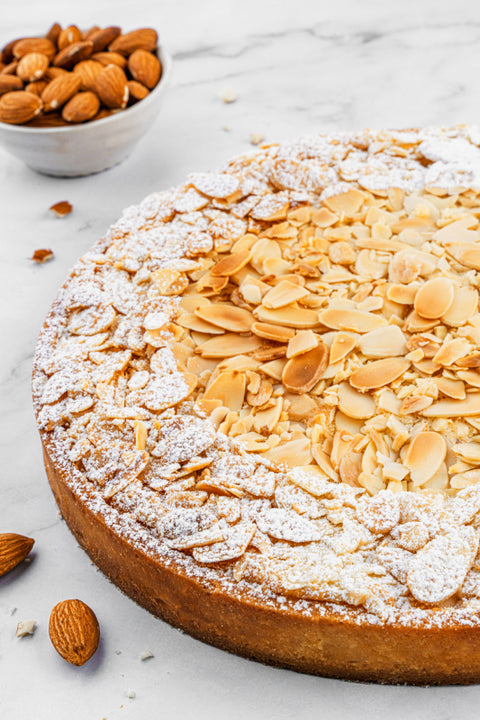 Image of full size Almond Tart, beautifully garnished with sliced almonds, a perfect nutty treat for almond enthusiasts from our home bakery