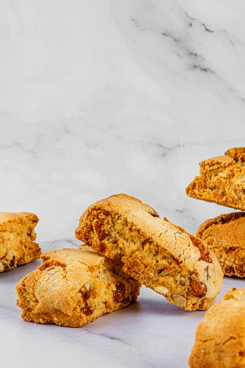 An image of freshly baked Almond Biscottis, arranged elegantly, showcasing their golden-brown color and the delightful presence of whole almonds within each biscotti