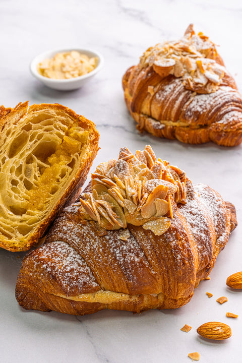 Image of Double Baked Almond Croissant, generously filled with almond cream and topped with sliced almonds, a mouth-watering nutty treat from our home bakery