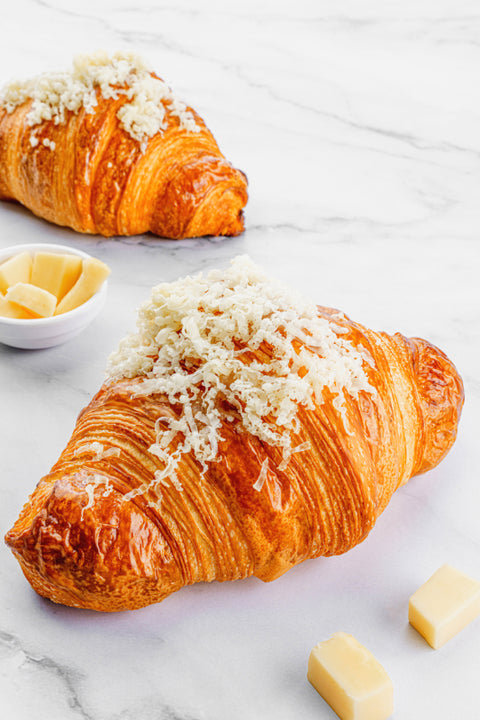 Image of a Cheese Croissant, showcasing its flaky, golden exterior and a generous filling of premium cheese.
