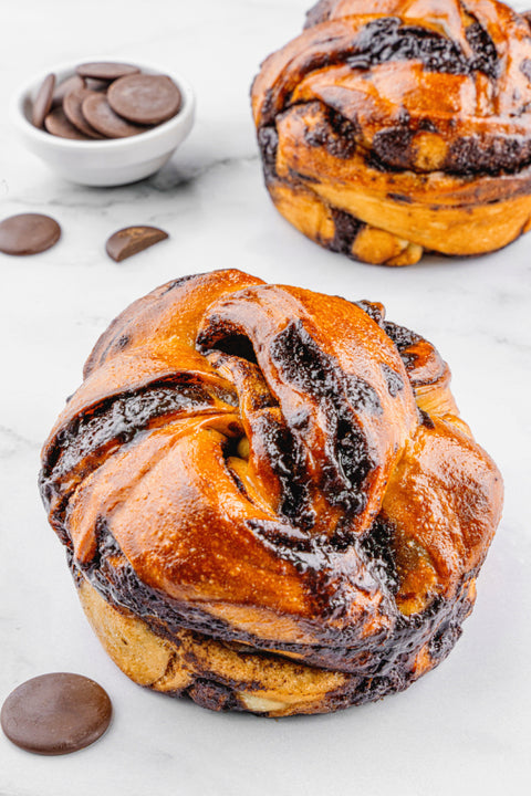 Image of a Chocolate Babka by Laura Bakery, displaying its intricate layers of chocolate swirls and golden-brown, twisted pastry.