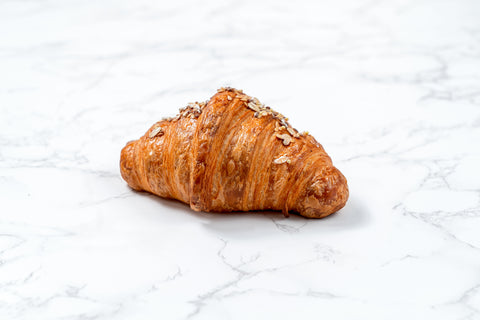 Image of an Emmental Croissant from Laura's Home Bakery, showcasing its flaky layers and a generous filling of Emmental cheese, perfectly baked to golden perfection.