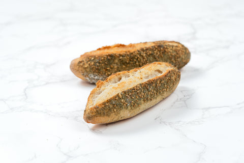 Image of a Mini Zaatar Sourdough Baguette from Laura's Home Bakery, showcasing its rustic exterior and the fragrant blend of za'atar herbs mixed into the dough.