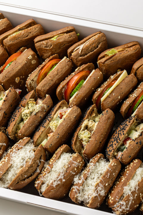 Assorted mini sandwiches in a white container