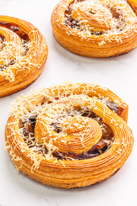 Image of Mushroom and Swiss Rolls from Laura's Home Bakery, showcasing their fluffy golden crust and a luscious filling of sautéed mushrooms and Swiss cheese.