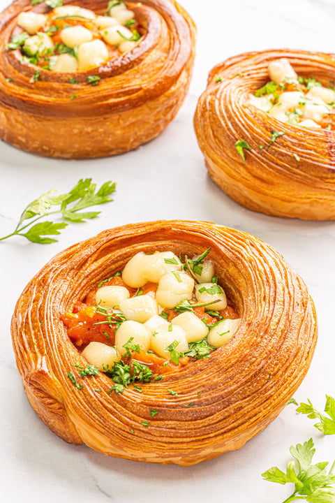 Image of a Pizza Tomato Danish from Laura's Home Bakery, showcasing its savory tomato sauce, melted cheese, and flaky pastry layers.