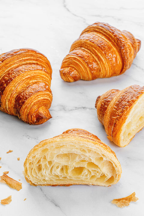 Close-up view revealing the soft, tender layers of the interior of a Plain Croissant from Laura's Home Bakery, a delightful and flaky masterpiece.