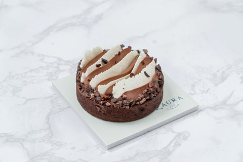 Image of a mini Triple Chocolate Tart with White Vanilla Ganache and Chocolate Whipped Cream from Laura's Home Bakery, showcasing its luxurious toppings and decadent chocolate layers.