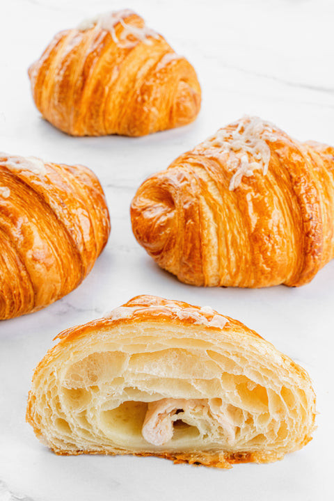 Image of a Turkey & Cheese Croissant from Laura's Home Bakery, showcasing its flaky texture, tender turkey slices, and premium cheese filling.