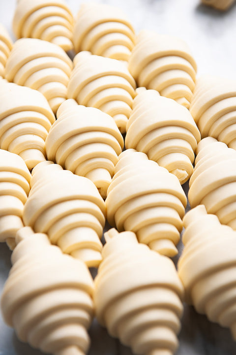Image of Plain Pure Butter Croissant - Frozen from Laura's Home Bakery, showcasing their convenient frozen state, ready to be baked to perfection.